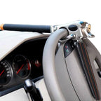 Hands demonstrating tool-free installation of triple lock steering wheel security device