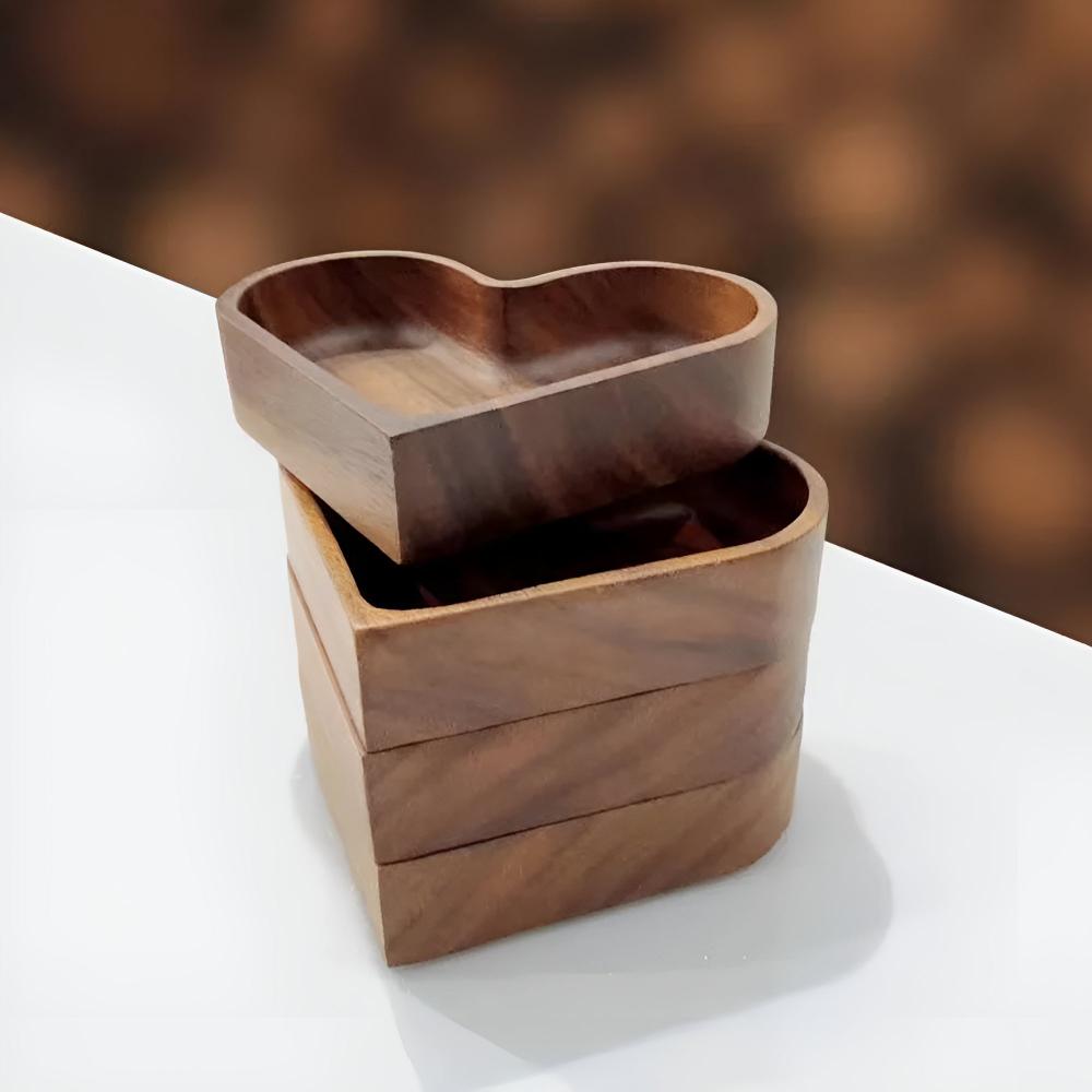 Heart-shaped walnut wooden bowl set on dining table styled with wine glasses and candles in cosy Australian home setting