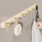 White wall coat rack in hallway context with timber flooring and rattan basket, natural daylight lifestyle shot