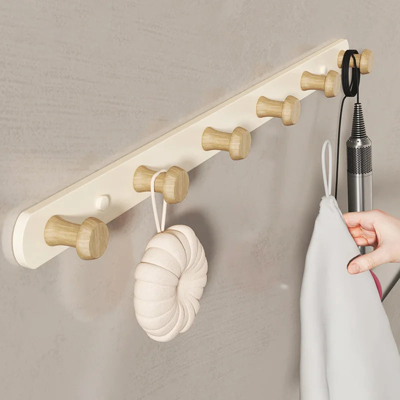 White wall coat rack in hallway context with timber flooring and rattan basket, natural daylight lifestyle shot