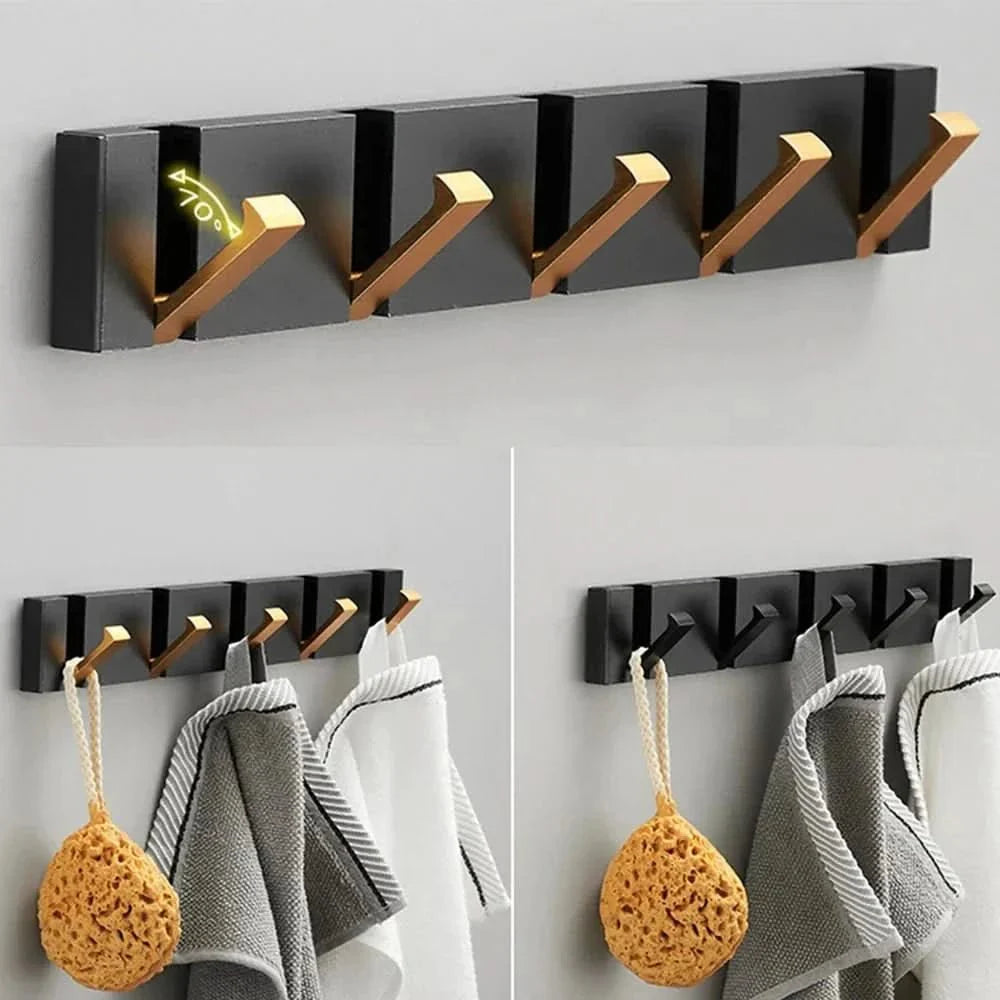 Six-hook black gold wall hook rail bathroom setting multiple neutral towels hanging white tile wall