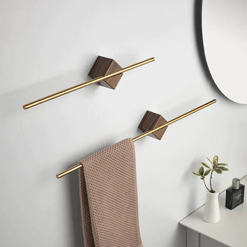 Full bathroom wall with two staggered walnut wood towel bars, round mirror, and minimal accessories in neutral tones