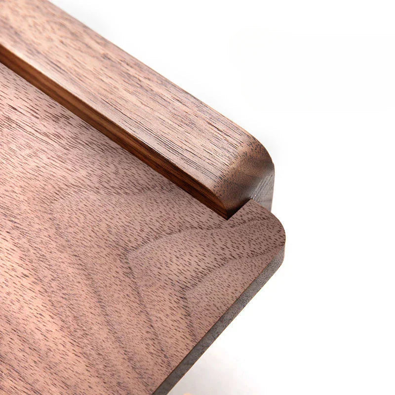 Close-up of walnut wood grain shelf surface of toilet roll holder, warm brown tones and natural wood texture visible