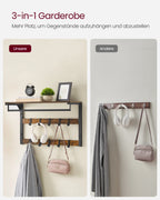 Full hallway scene with wall coat rack above a storage bench, hat and yellow scarf hanging, plant and framed print on top shelf