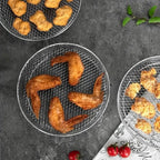Close-up of food-safe stainless steel 304 mesh weave texture on stackable air fryer basket showing open grid design