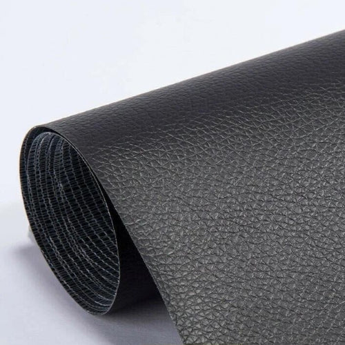 Close-up of beige-white leather repair patch surface showing material grain texture and finish quality