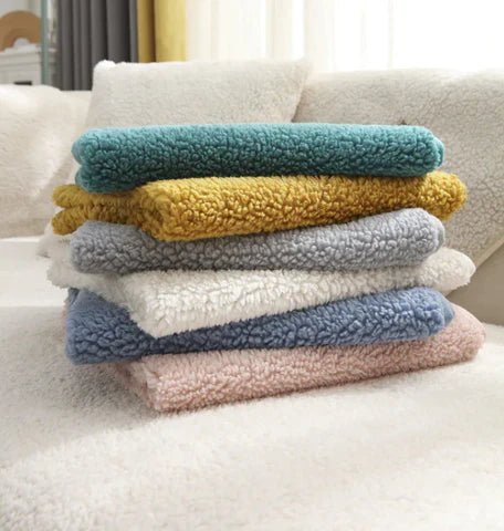 Hands demonstrating anti-slip mat placement under teddy fleece sofa cover installation guide