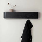 Close-up of walnut-finish wood grain texture and rounded edges on wall-mounted shelf rack