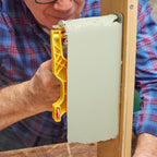 Close-up of metal paint shield on roller edger tool showing edge guide detail and textured roller head