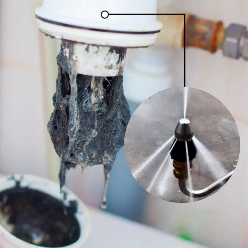 Stainless steel drain nozzle in use inside a pipe with high-pressure water jet clearing debris and blockage