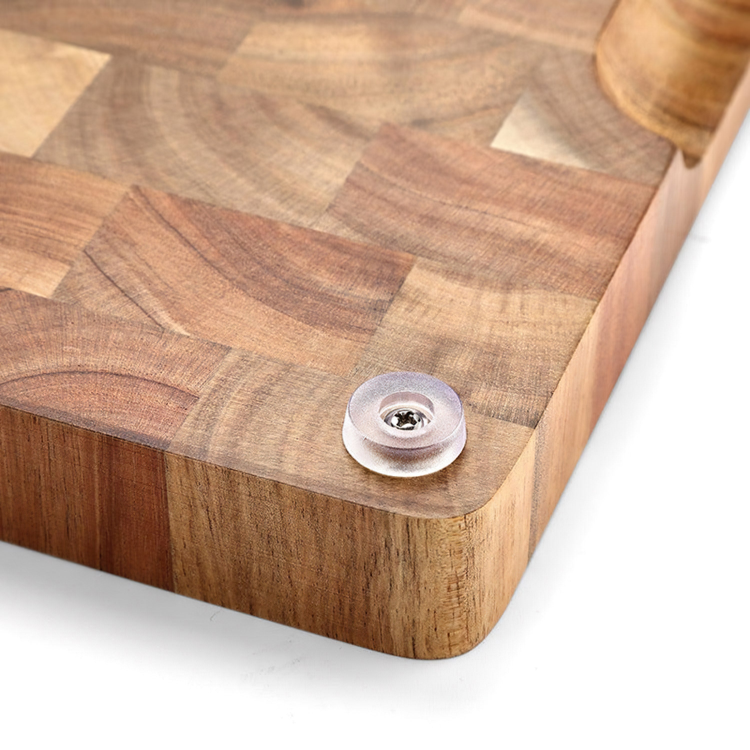 Person holding acacia wood cutting board by side grips showing easy transport handling feature