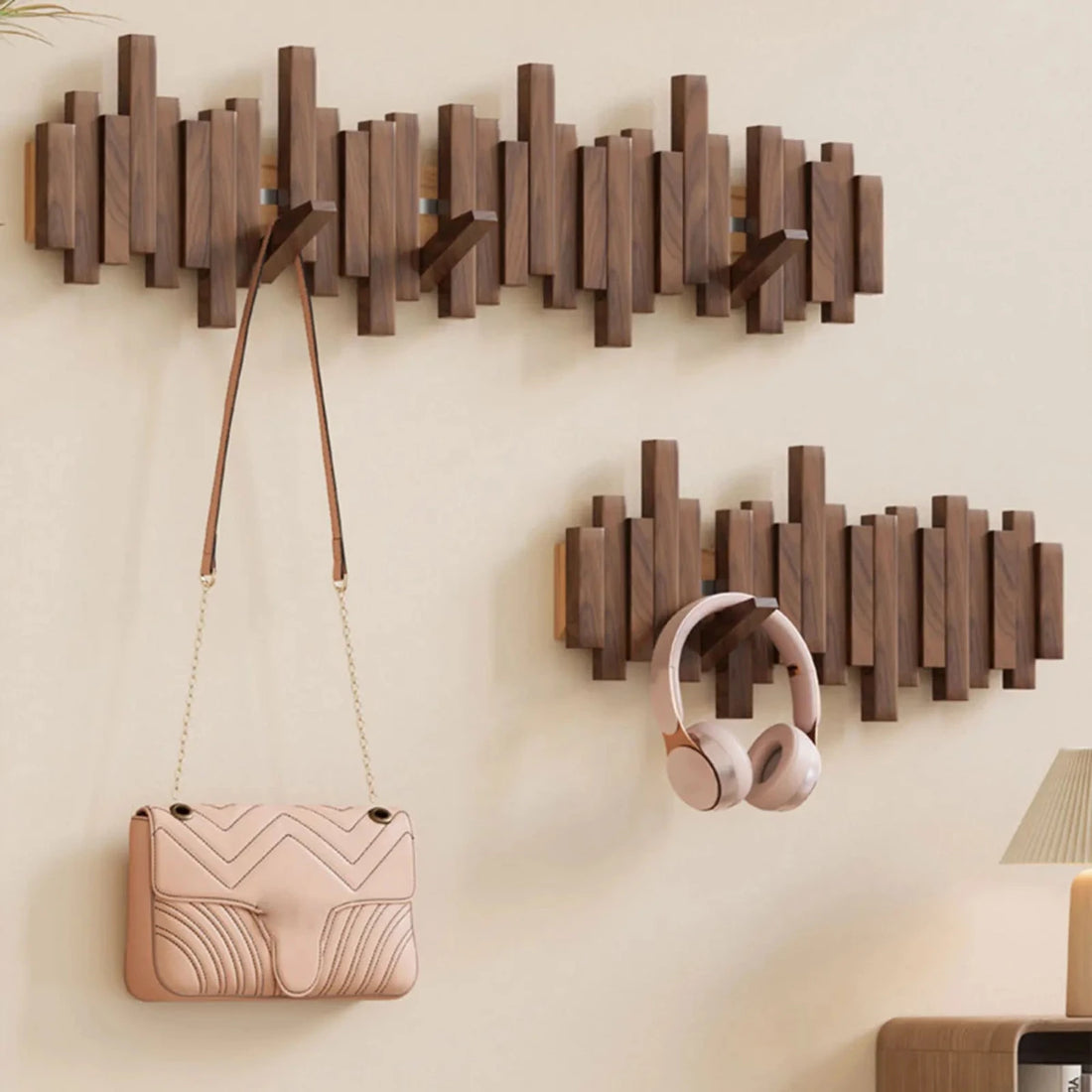 Hand hanging beige coat on solid wood hook demonstration