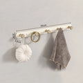 Wall coat rack components flat-lay on grey surface with eucalyptus branch and neutral ceramic accessories