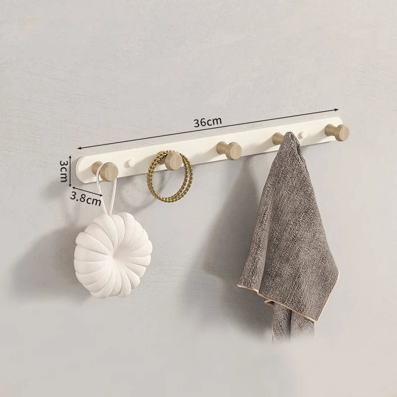 Wall coat rack components flat-lay on grey surface with eucalyptus branch and neutral ceramic accessories