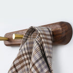Beech wood 2-hook wall rack in bathroom with white waffle towel and robe hanging, natural light