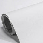 Grey self-adhesive leather repair patch applied to worn handbag strap styled on bench in Australian home