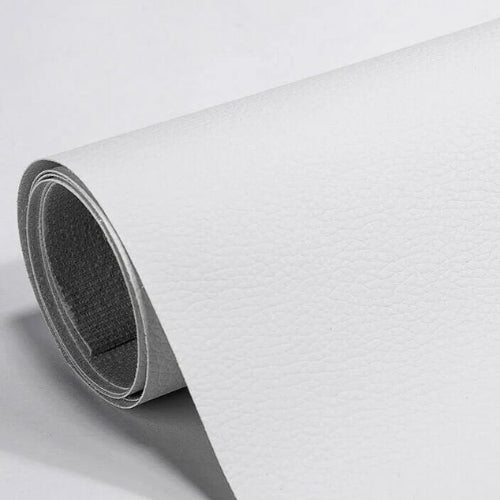 Grey self-adhesive leather repair patch applied to worn handbag strap styled on bench in Australian home